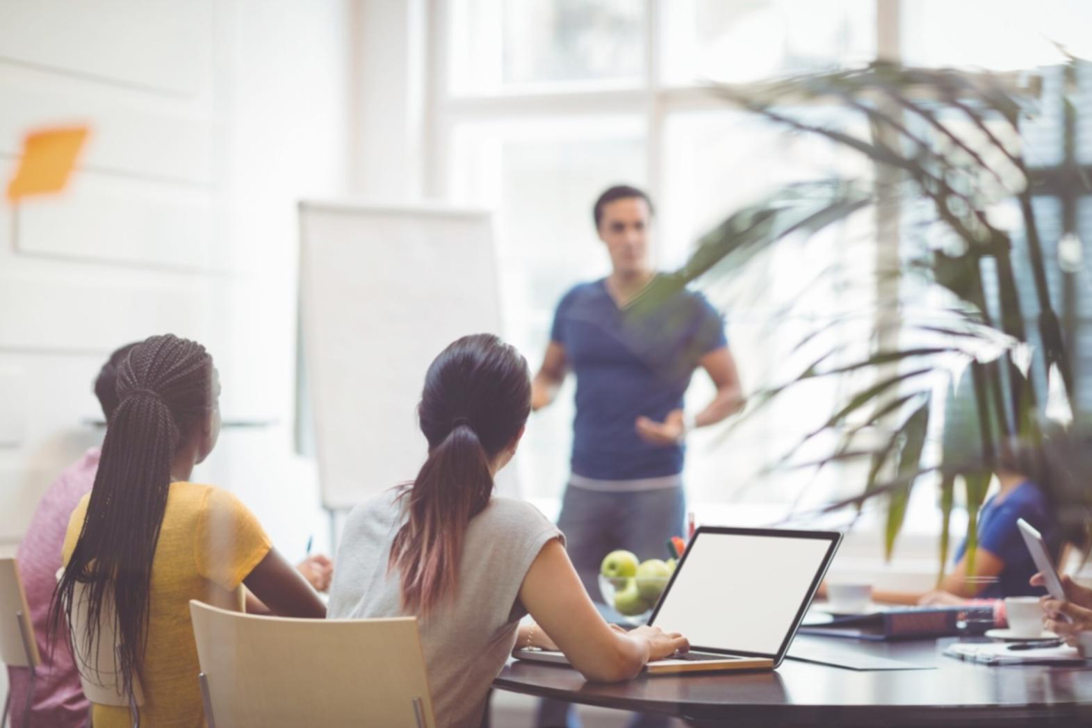 Collaborative workshop environment showing entrepreneurs working together on business planning